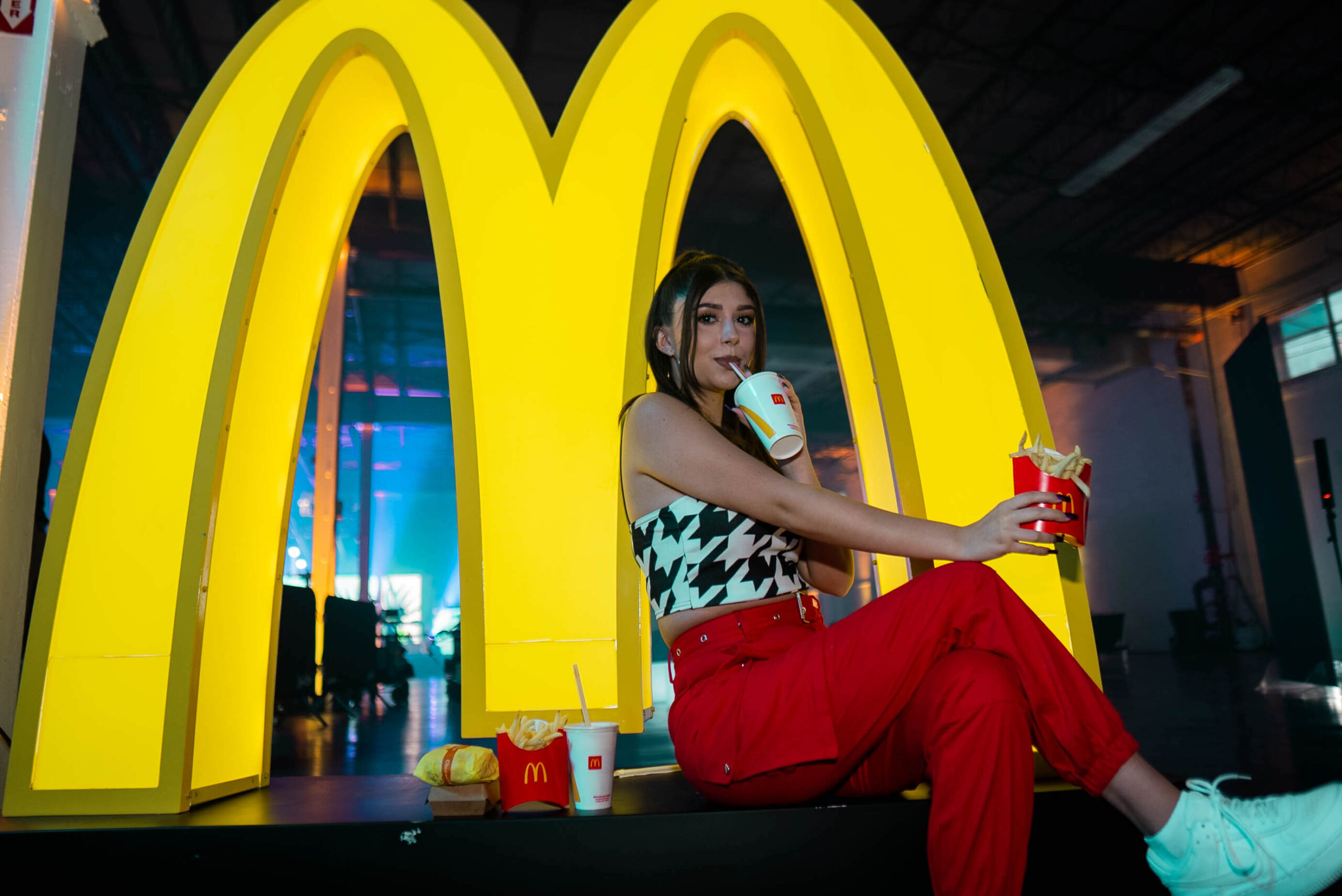 Woman enjoying McDonald’s soda and french fries
